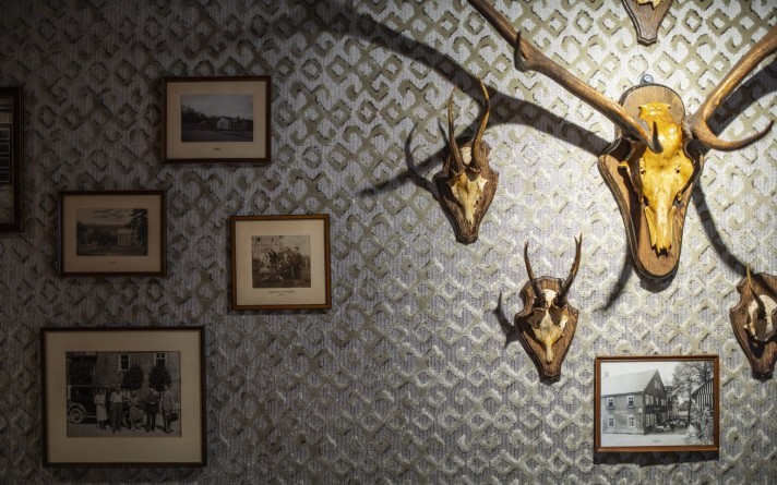 Hunting trophies and historical photographs adorn the walls of the Jagdstube restaurant in the Hotel Jagdhaus Wiese in the Sauerland region