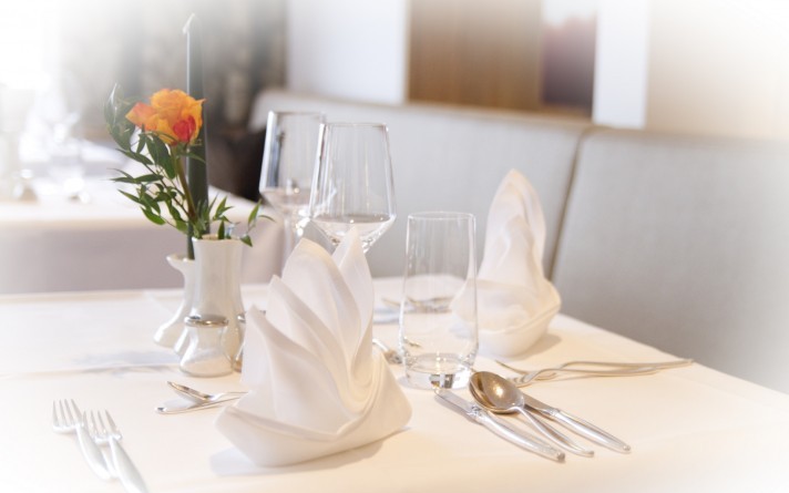 Festively laid evening table in the park restaurant at the Hotel Jagdhaus Wiese in the Sauerland