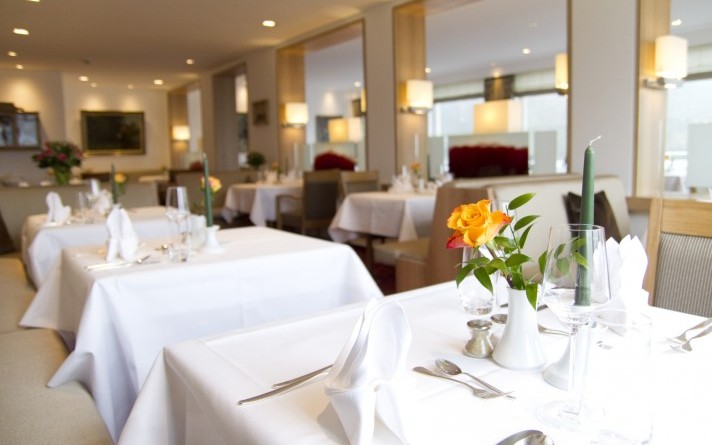 Festively laid tables in the park restaurant at the Hotel Jagdhaus Wiese in the Sauerland