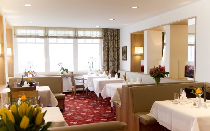 Set tables in the park restaurant at the Hotel Jagdhaus Wiese in the Sauerland