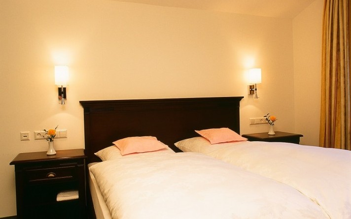 Bedroom of the Schwalbennest holiday flat in the Schneisberghaus belonging to the Hotel Jagdhaus Wiese in the Sauerland