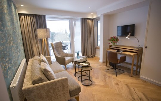 Living room with large desk in an Exclusive suite at the Hotel Jagdhaus Wiese in the Sauerland